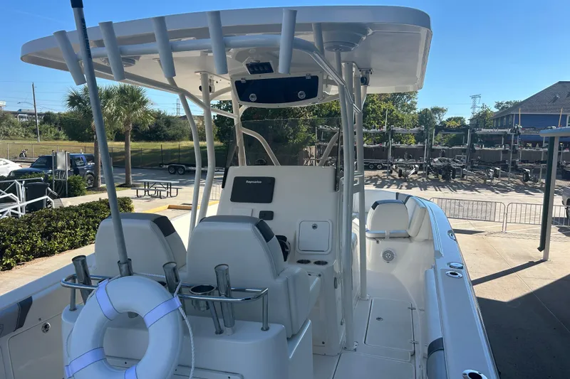 Slide: The Image of 2015 Century 2901 Center Console boat with T-top and seating, docked outdoors. - 37