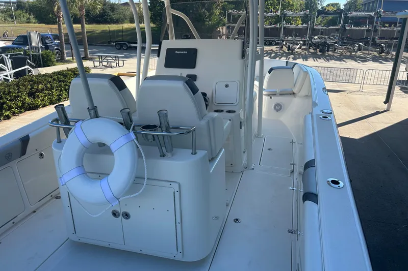Slide: The Image of 2015 Century 2901 Center Console boat with seating and life preserver, docked outdoors. - 38
