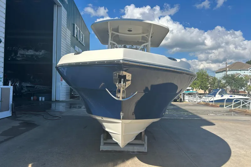 Slide: The Image of 2015 Century 2901 Center Console boat on a dock under a blue sky. - 4