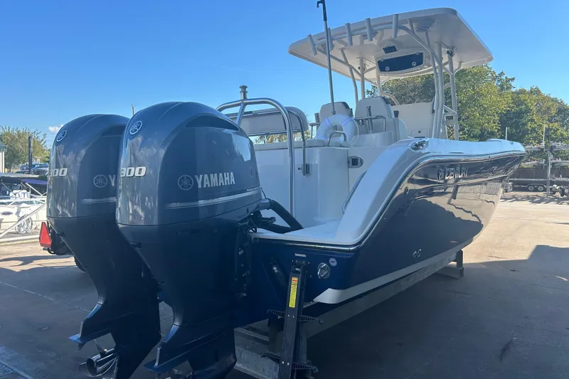 Slide: The Image of 2015 Century 2901 Center Console boat with dual Yamaha 300 engines, docked outdoors. - 8