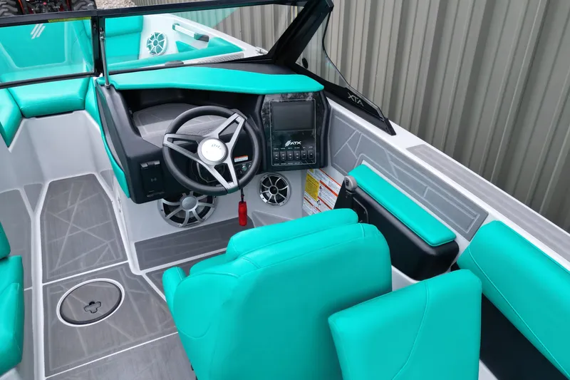 Slide: The Image of 2021 ATX Surf Boats 20 Type-S interior with teal seating and modern dashboard. - 11
