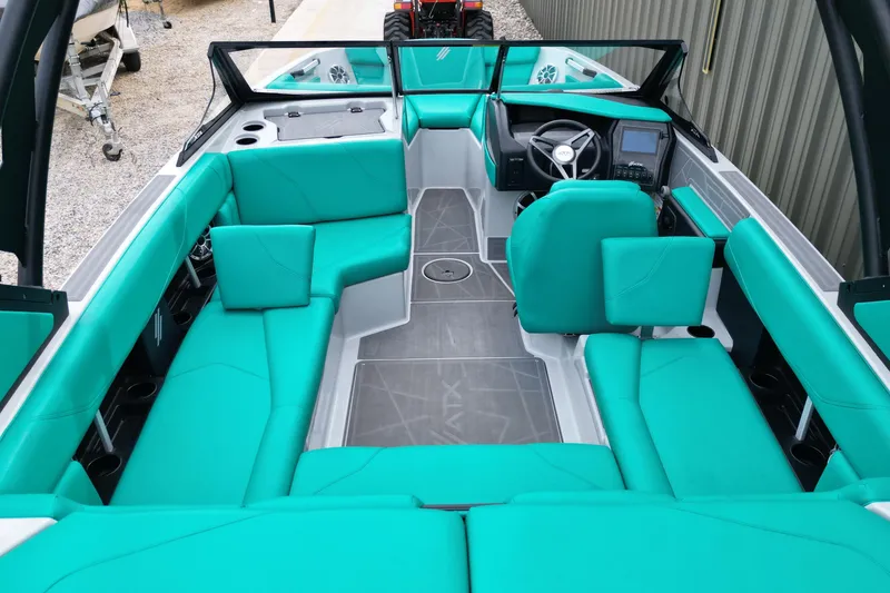 Slide: The Image of 2021 ATX Surf Boats 20 Type-S interior with teal seating and modern dashboard. - 13