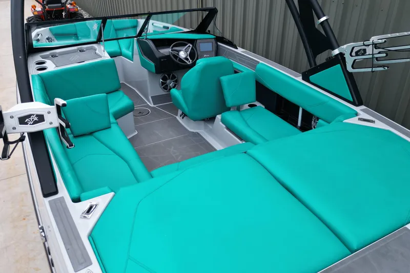 Slide: The Image of 2021 ATX Surf Boats 20 Type-S interior with teal seating and modern dashboard. - 14