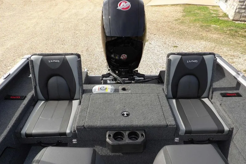 Slide: The Image of 2026 Lund 1875 Impact XS Sport boat interior with carpeted deck and storage compartments. - 10