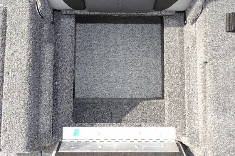 Slide: The Image of 2026 Lund 1875 Impact XS Sport boat interior with storage compartment and fishing net. - 16