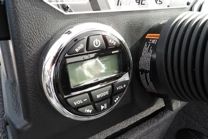 Slide: The Image of 2026 Lund 1875 Impact XS Sport boat cockpit with steering wheel and dashboard controls. - 22