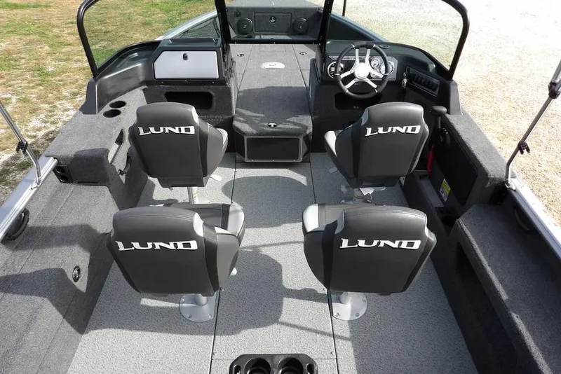 Slide: The Image of Dashboard gauges of 2026 Lund 1875 Impact XS Sport boat, showing RPM, trim, and fuel levels. - 23