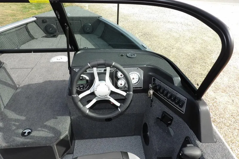 Slide: The Image of Control panel of 2026 Lund 1875 Impact XS Sport boat with keys and switches. - 24