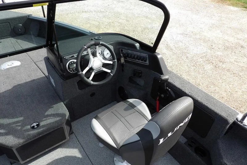 Slide: The Image of 2026 Lund 1875 Impact XS Sport boat interior with storage compartments and seating. - 27