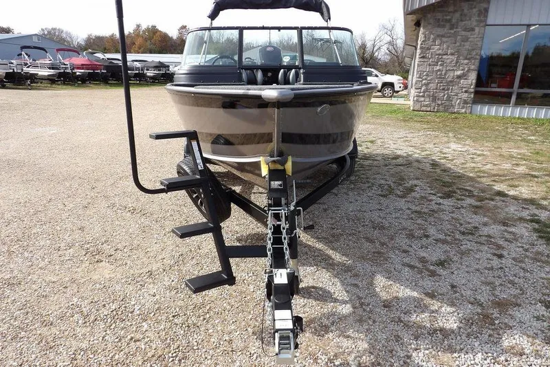 Slide: The Image of 2026 Lund 1875 Impact XS Sport boat on trailer outside marine center. - 3