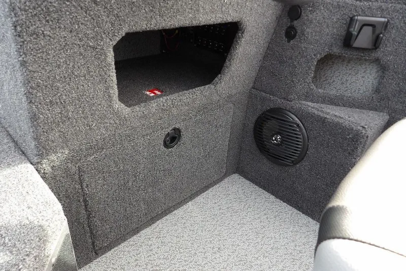 Slide: The Image of 2026 Lund 1875 Impact XS Sport boat storage compartment with logo. - 32