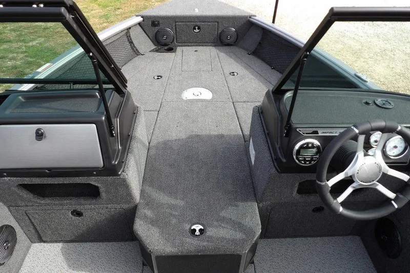 Slide: The Image of Interior of 2026 Lund 1875 Impact XS Sport boat, featuring storage and speaker. - 35