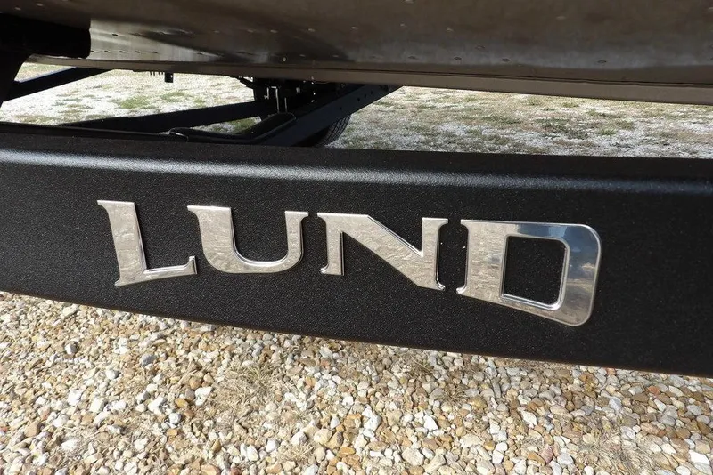 Slide: The Image of 2026 Lund 1875 Impact XS Sport trailer wheel on gravel surface. - 45