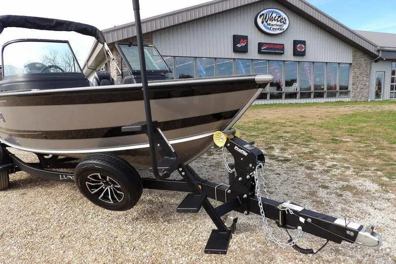 Slide: The Image of 2026 Lund 1875 Impact XS Sport boat interior with spacious, carpeted deck and storage compartments. - 46