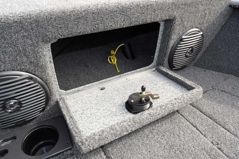 Slide: The Image of 2026 Lund 1875 Impact XS Sport boat interior with chrome details and safety warning label. - 49