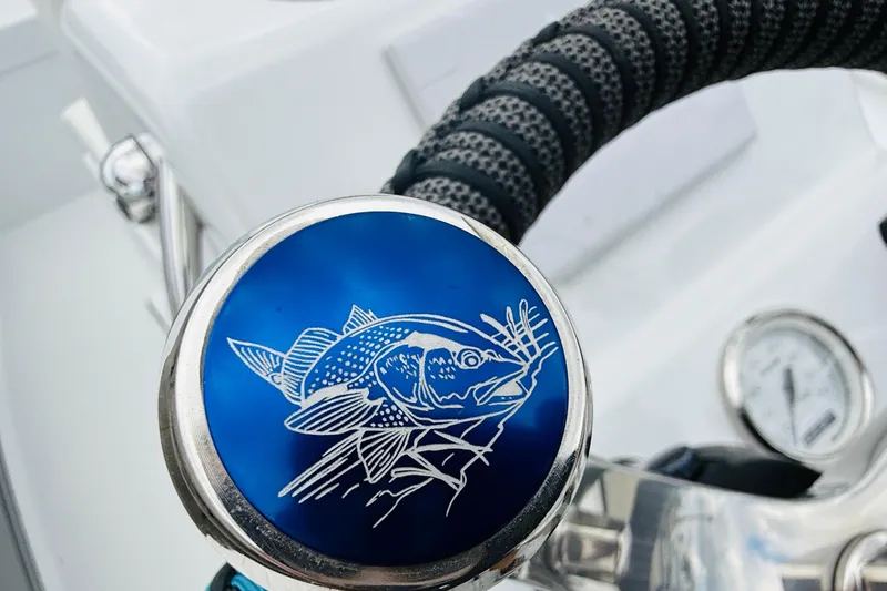 Slide: The Image of Close-up of 2021 Beavertail Skiffs 18 Mosquito steering wheel with fish emblem. - 14