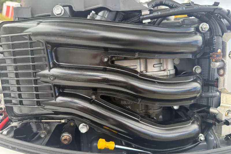 Slide: The Image of Close-up of a 2021 Beavertail Skiffs 18 Mosquito engine, showcasing intricate components. - 15