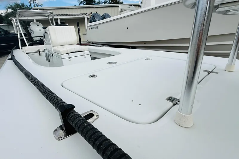 Slide: The Image of 2021 Beavertail Skiffs 18 Mosquito boat, white deck, sleek design, outdoor setting. - 5