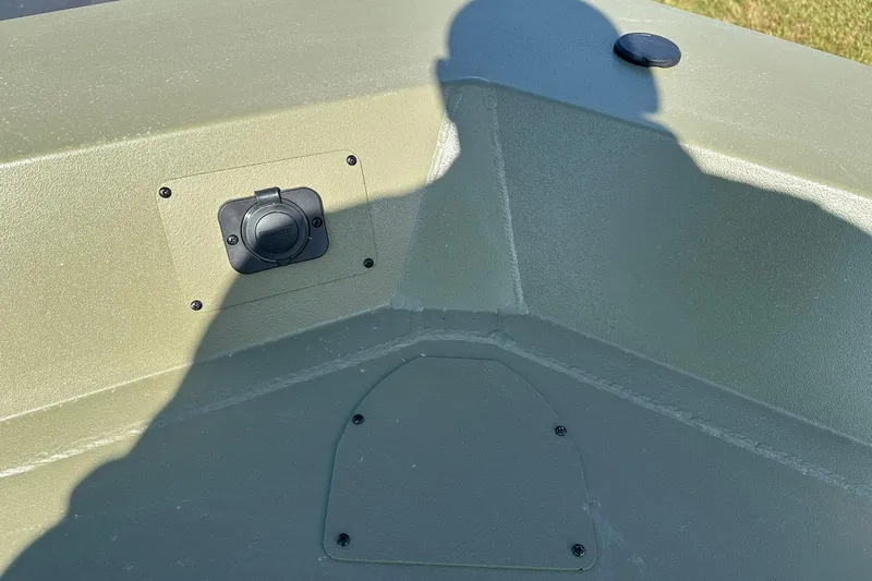 Slide: The Image of 2026 Lowe Roughneck 1860SC boat interior with shadow and mounted accessory. - 12