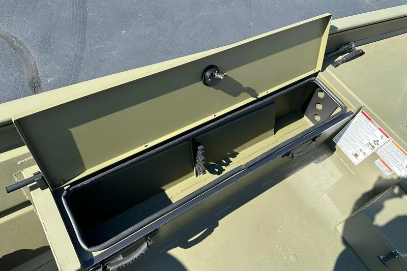 Slide: The Image of Open storage compartment in 2026 Lowe Roughneck 1860SC boat, showing interior details. - 14