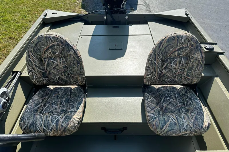 Slide: The Image of 2026 Lowe Roughneck 1860SC boat with camo-patterned seats and spacious deck. - 15