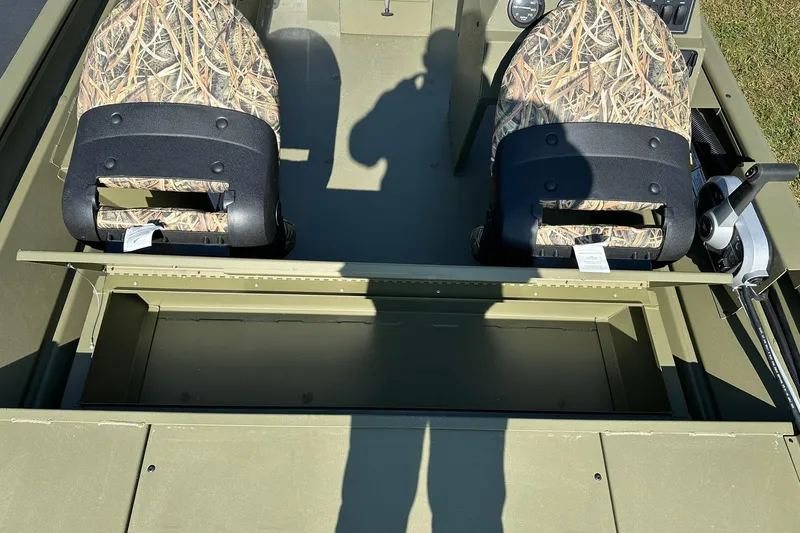 Slide: The Image of 2026 Lowe Roughneck 1860SC boat interior with camo seats and storage compartment. - 16