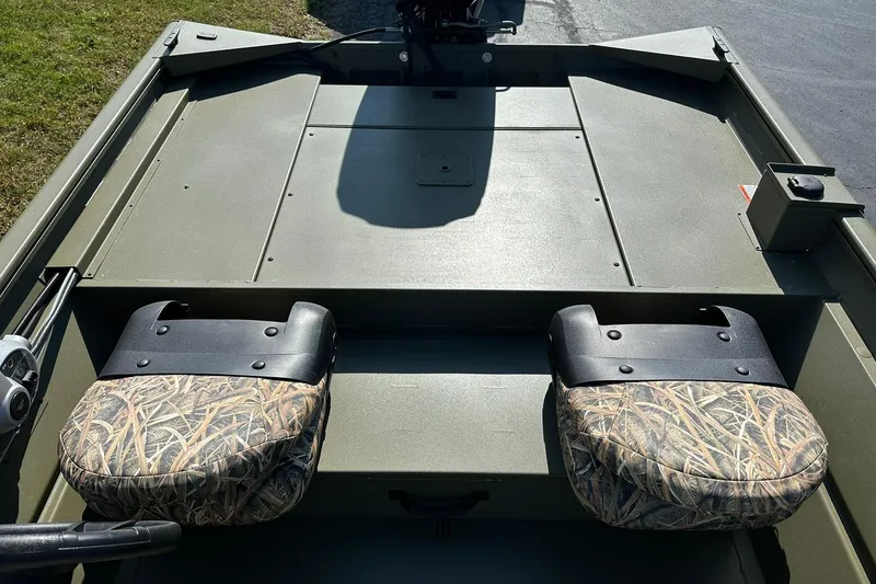 Slide: The Image of 2026 Lowe Roughneck 1860SC boat interior with camo seats and spacious deck. - 17