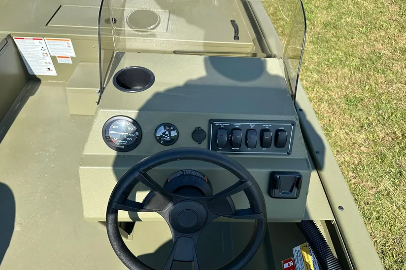 Slide: The Image of 2026 Lowe Roughneck 1860SC boat console with steering wheel and control panel. - 19