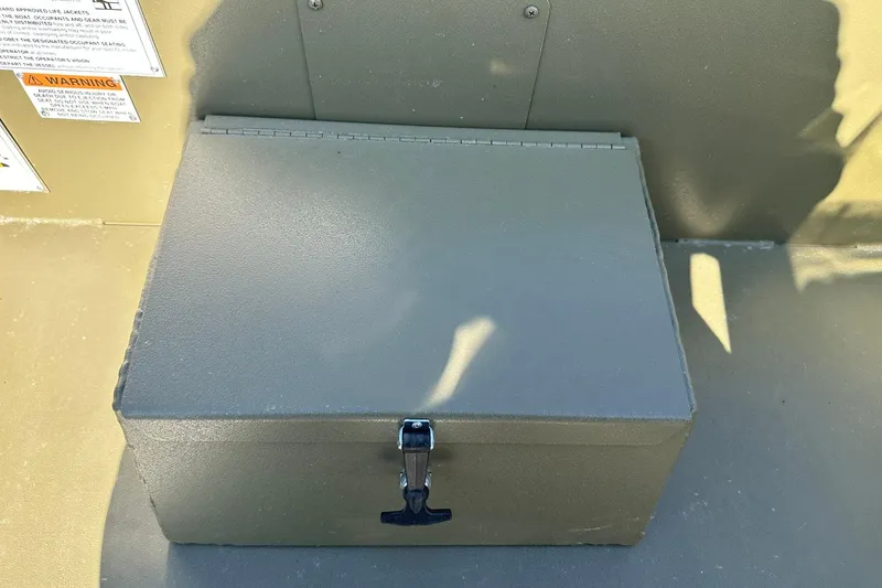 Slide: The Image of Storage compartment on a 2026 Lowe Roughneck 1860SC boat, featuring a secure latch. - 20