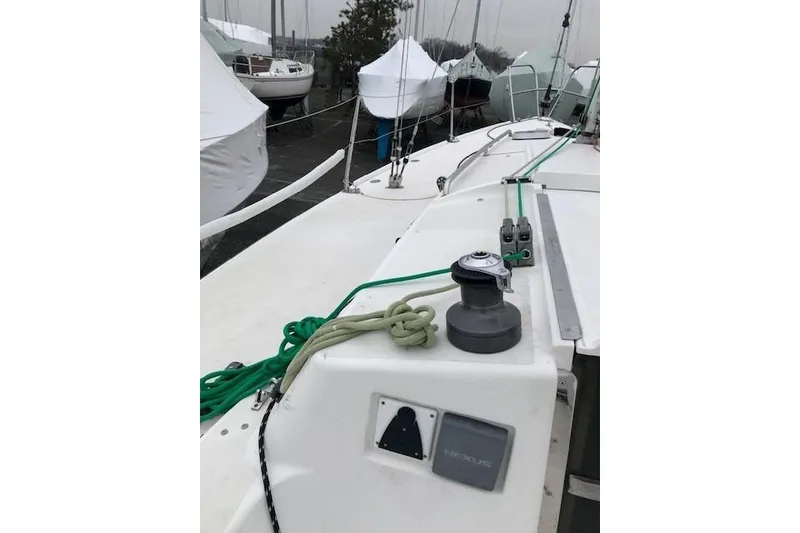 Slide: The Image of 1997 JBoat J 105 sailboat deck with winch and green ropes. - 14