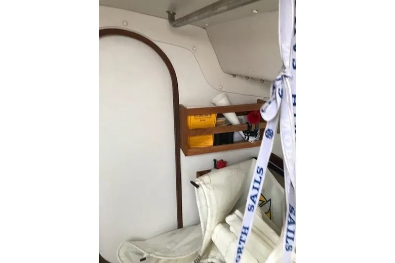 Slide: The Image of Interior of a 1997 JBoat J 105 sailboat with sails and storage area. - 18