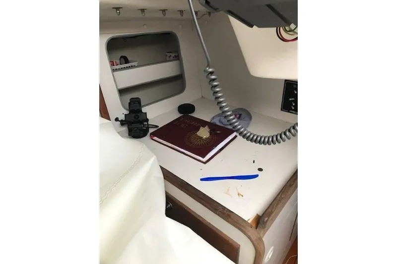 Slide: The Image of Interior of a 1997 JBoat J 105 with navigation equipment and a book on the desk. - 21