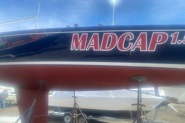 Slide: The Image of 1997 JBoat J 105 sailboat named "Madcap" on display, featuring a sleek hull design. - 23