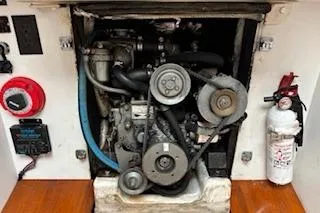 Slide: The Image of Engine compartment of a 1997 J Boats J 105 sailboat, featuring mechanical components and safety equipment. - 29