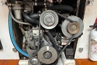 Slide: The Image of Engine compartment of a 1997 J Boats J 105 sailboat, featuring belts and hoses. - 31