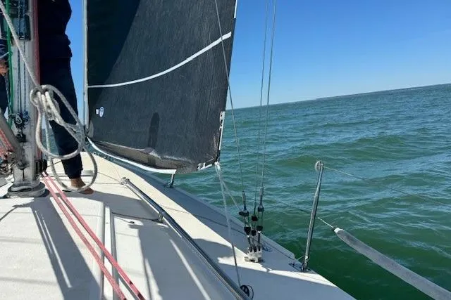 Slide: The Image of Sailing on a 1997 JBoat J 105 with black sails on open water. - 7