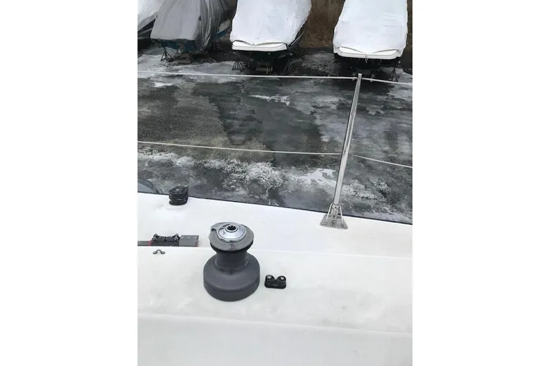 Slide: The Image of Deck of a 1997 JBoat J 105 with winch and covered boats in background. - 9