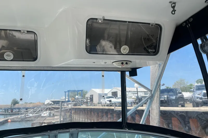 Slide: The Image of Interior view of a 2002 Century 3200 Walk-Around boat with dockside background. - 13