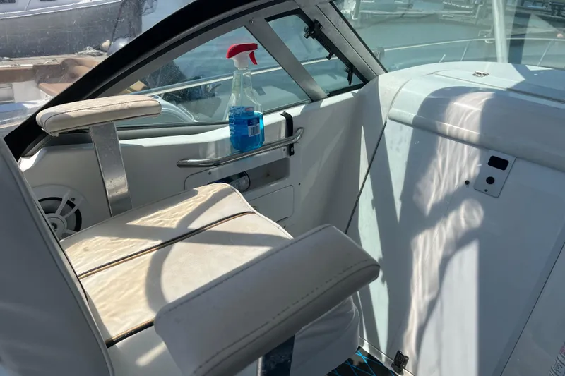 Slide: The Image of Interior of a 2002 Century 3200 Walk-Around boat with seating and cleaning spray bottle. - 14