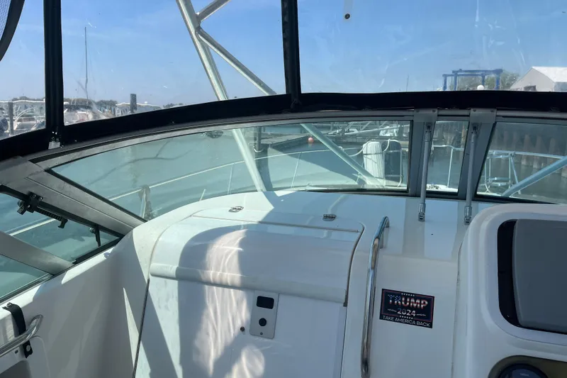 Slide: The Image of 2002 Century 3200 Walk-Around boat interior with windshield and marina view. - 15