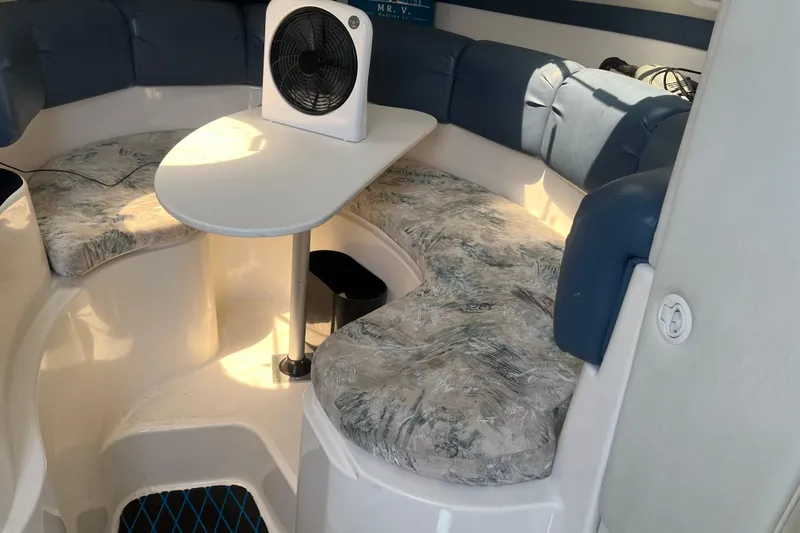 Slide: The Image of Interior of a 2002 Century 3200 Walk-Around boat with seating and table. - 20