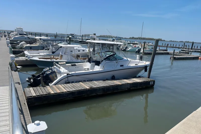 Slide: The Image of Century 3200 Walk-Around 2002 boat docked at marina on a sunny day. - 4