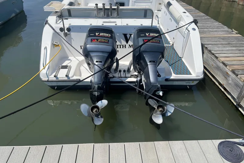 Slide: The Image of 2002 Century 3200 Walk-Around boat with twin Yamaha V250 outboard motors docked. - 6
