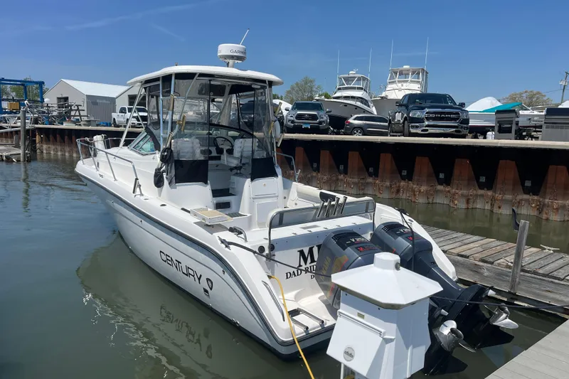Slide: The Image of Century 3200 Walk-Around boat docked at marina, 2002 model, with twin outboard engines. - 8