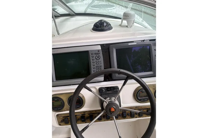 Slide: The Image of Century 3200 WA 2004 boat dashboard with steering wheel and navigation equipment. - 3