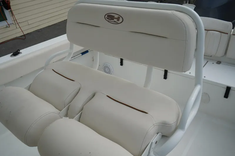 Slide: The Image of 2022 Sea Hunt Ultra 229 boat seat with white cushioned upholstery. - 15