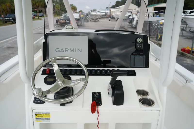Slide: The Image of 2022 Sea Hunt Ultra 229 boat console with Garmin display and steering wheel. - 17