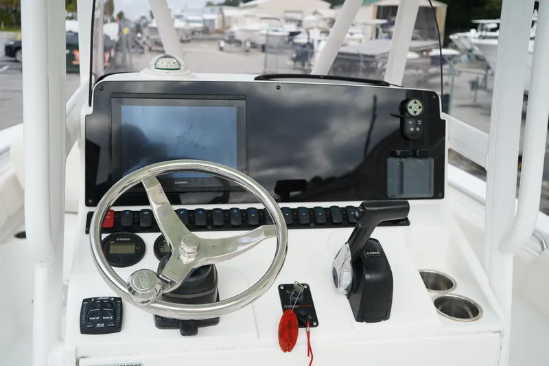 Slide: The Image of 2022 Sea Hunt Ultra 229 boat dashboard with steering wheel and controls. - 19