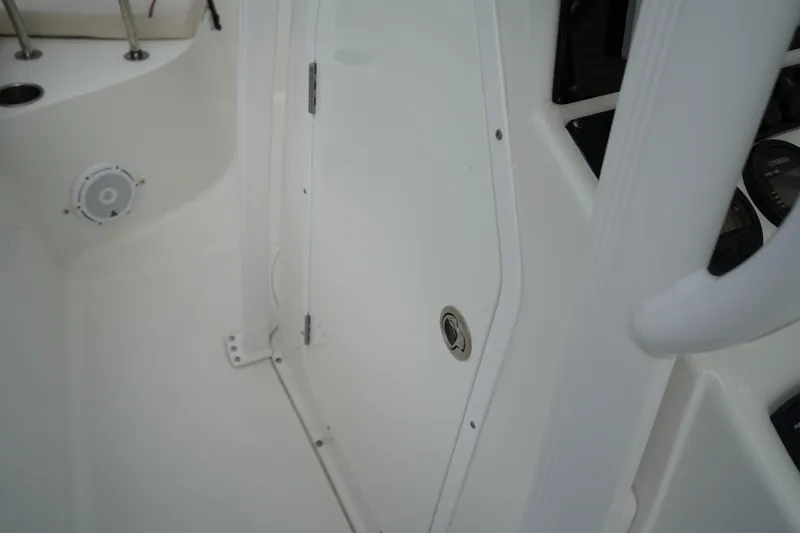 Slide: The Image of Interior view of 2022 Sea Hunt Ultra 229 boat, featuring a white cabin door and speaker. - 20
