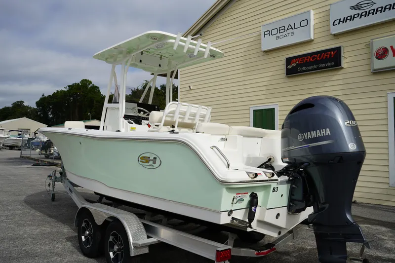 Slide: The Image of 2022 Sea Hunt Ultra 229 boat with Yamaha engine on trailer, parked near dealership. - 4